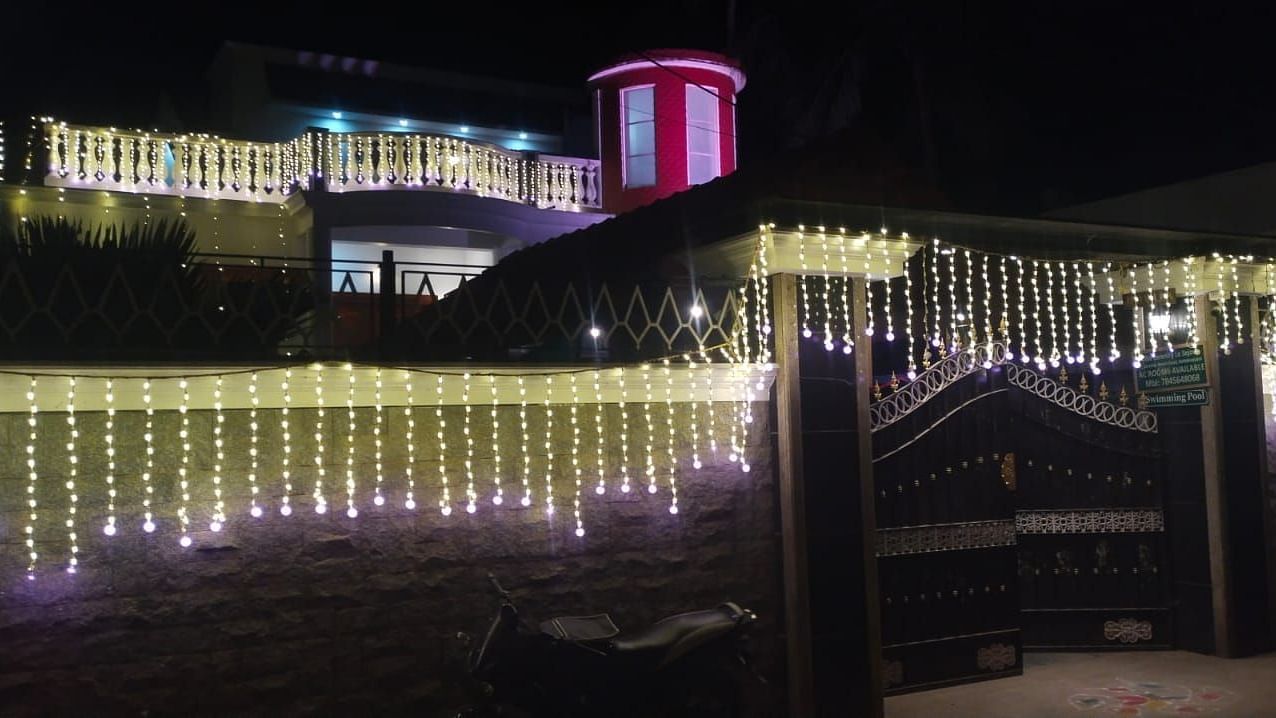 Night view of Villa Serenity Le Sejour Pondicherry decorated with lights.